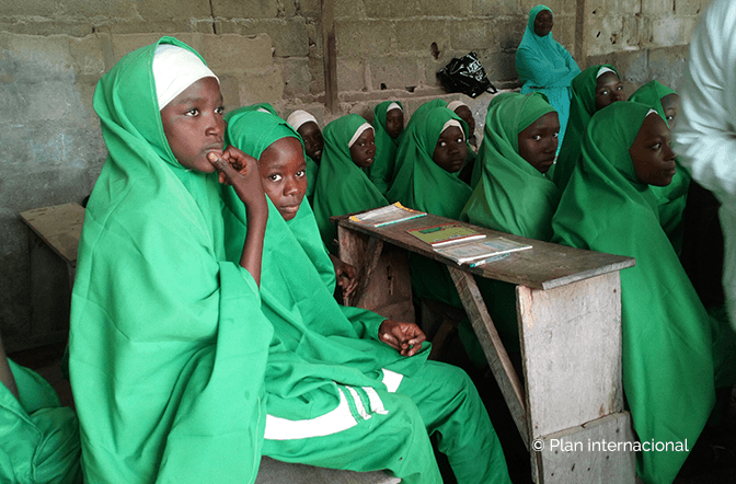 Plan International - Girls sitting in school